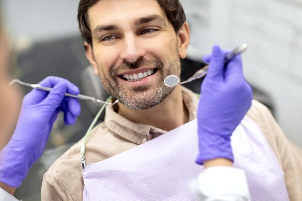 Man smiling getting teeth cleaned, glendale ca