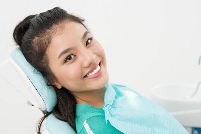 Woman smiling in dental exam chair