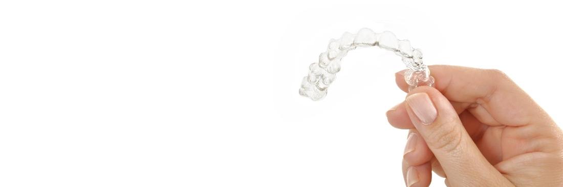 female hand holding Invisalign | Dentist Glendale CA