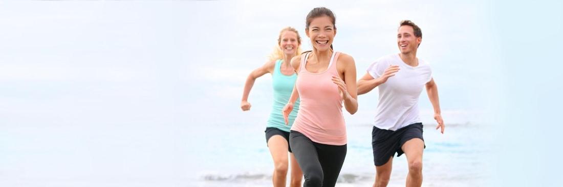 adults running on beach | Dentist Glendale CA