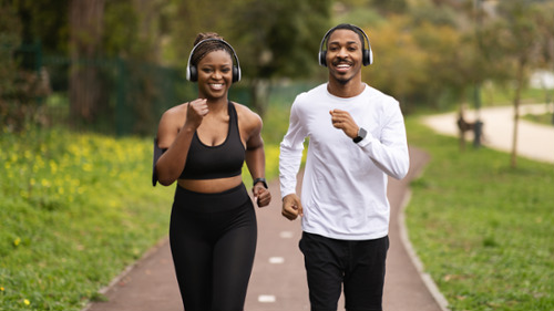 Black man and woman jogging with headphones on, glendale ca