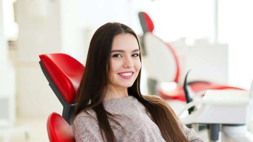 Woman with brown hair smiling in dental chair, glendale ca