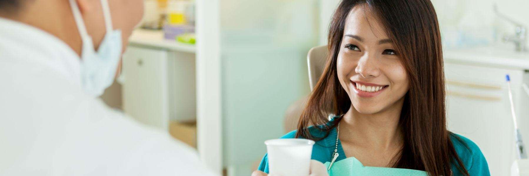 Asian women smiling in dental chair before veneers, glendale ca